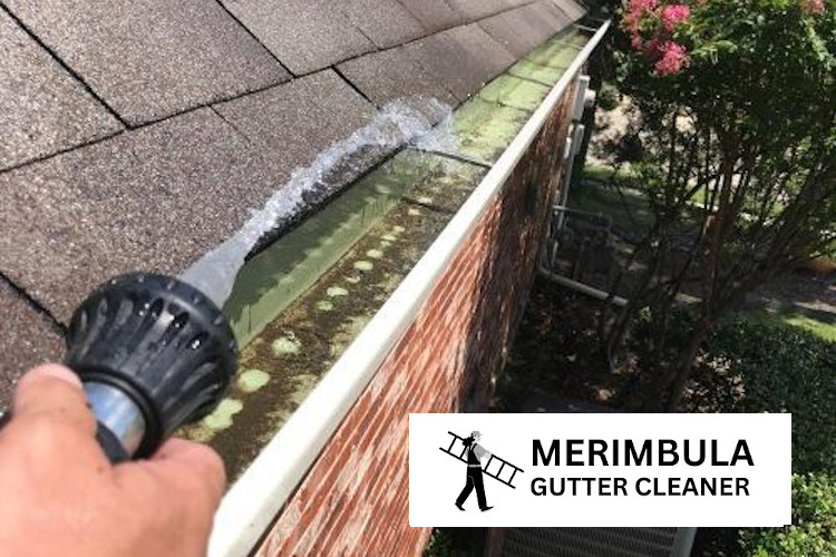 Gutters being rinsed out by a gutter cleaner in Merimbula 